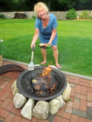 Chris Lyons grilling food over fire