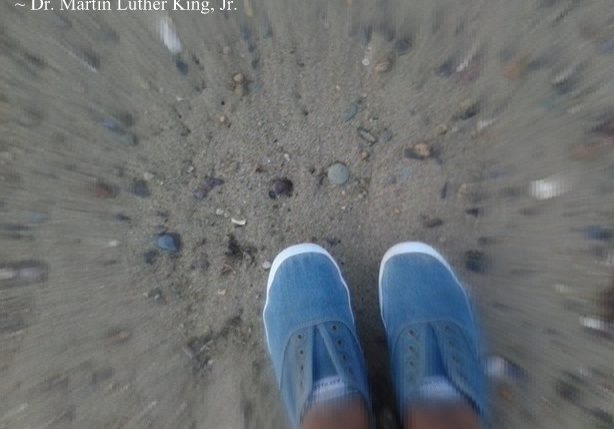 Sneakers on beach with quote