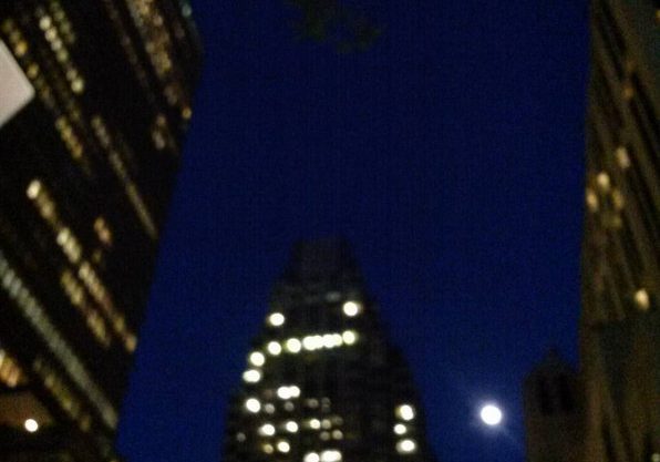 moonrise in Boston against skyscrapers